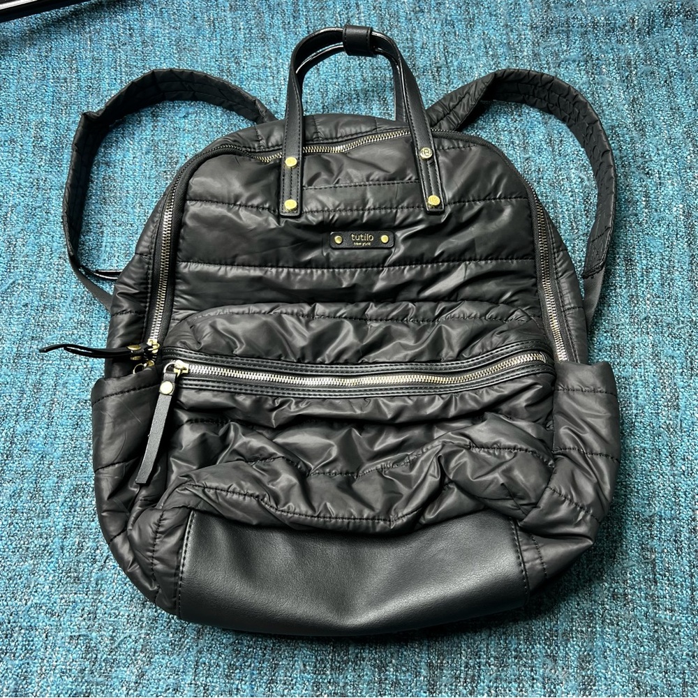 Tutilo Travel Backpack in Black with Gold Quilted Luggage Trolley Sleeve Pocket